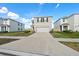 Two story home featuring neutral paint, dark shutters, two car garage, and landscaping at 10523 Penny Gale Loop, San Antonio, FL 33576