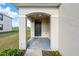 Inviting covered front porch with a stylish black front door and neutral-toned exterior at 10523 Penny Gale Loop, San Antonio, FL 33576