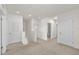 Bright hallway features neutral carpet, white walls, and classic doors leading to various rooms at 10523 Penny Gale Loop, San Antonio, FL 33576