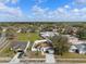 Aerial view of a home with solar panels, a fenced yard, and surrounding neighborhood at 4604 Hunts Ave, Plant City, FL 33566