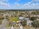 Neighborhood aerial view with mature trees, well-maintained roads and single Gathering homes under a partly cloudy sky at 4604 Hunts Ave, Plant City, FL 33566