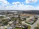Aerial view of neighborhood homes, tree lined streets, and nearby commercial buildings on a sunny day at 4604 Hunts Ave, Plant City, FL 33566