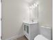 Bathroom featuring a stylish vanity with a mirror and lights, accompanied by a toilet at 4604 Hunts Ave, Plant City, FL 33566