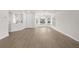 Bright living room featuring wood-look flooring, white walls, and large windows at 4604 Hunts Ave, Plant City, FL 33566