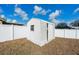 A white shed with vertical siding and a single window, enclosed by a fence at 4604 Hunts Ave, Plant City, FL 33566