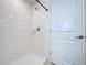 Modern bathroom featuring sleek shower fixtures, a white door, and bright lighting at 6744 Back Forty Loop, Zephyrhills, FL 33541