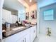 Bathroom features a large mirror, granite countertop, and ample vanity storage at 6744 Back Forty Loop, Zephyrhills, FL 33541