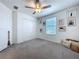Bright bedroom with carpet floors, fan, and window with blinds at 6744 Back Forty Loop, Zephyrhills, FL 33541