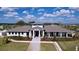 Stunning aerial shot of the clubhouse displaying the walkway, building architecture, and manicured landscaping at 6744 Back Forty Loop, Zephyrhills, FL 33541