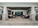 An inviting outdoor lounge with ample seating, a decorative ceiling, and stone pillars for relaxing and entertaining at 6744 Back Forty Loop, Zephyrhills, FL 33541