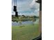 Scenic backyard featuring a tranquil lake view and lush green grass at 7037 Towering Spruce Dr, Riverview, FL 33578