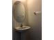 Bright bathroom features a pedestal sink and minimalist decor at 7037 Towering Spruce Dr, Riverview, FL 33578