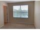 Comfortable bedroom featuring a window view of the community's serene lake at 7037 Towering Spruce Dr, Riverview, FL 33578