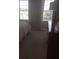 This bedroom boasts large windows providing natural light, and neutral walls at 7037 Towering Spruce Dr, Riverview, FL 33578
