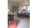 Carpeted dining room with table and chairs leading to kitchen at 7037 Towering Spruce Dr, Riverview, FL 33578