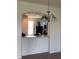 Chandelier hangs over a serving bar that looks into the kitchen area at 7037 Towering Spruce Dr, Riverview, FL 33578