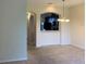 Beige dining room featuring carpet, chandelier, and arched kitchen view at 7037 Towering Spruce Dr, Riverview, FL 33578