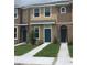 Townhome exterior featuring neutral tones and well-maintained landscaping at 7037 Towering Spruce Dr, Riverview, FL 33578