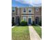 Charming townhome exterior with well-manicured lawn and inviting blue front doors at 7037 Towering Spruce Dr, Riverview, FL 33578