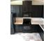 Modern kitchen with black appliances, ample cabinet space, and updated flooring at 7037 Towering Spruce Dr, Riverview, FL 33578