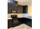 Modern kitchen featuring black appliances, ample cabinet space, and neutral countertops at 7037 Towering Spruce Dr, Riverview, FL 33578