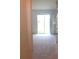 Bright living room featuring sliding glass doors to the backyard and neutral carpet at 7037 Towering Spruce Dr, Riverview, FL 33578