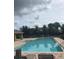 Sparkling community pool with lounge chairs and lush landscaping for relaxation at 7037 Towering Spruce Dr, Riverview, FL 33578