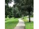 Winding sidewalk through a green landscape offering a pedestrian-friendly community at 7037 Towering Spruce Dr, Riverview, FL 33578