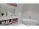 Modern bathroom featuring a soaking tub, double vanity, and decorative tile flooring at 15945 Viscount Cir, Port Charlotte, FL 33981