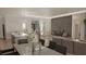 Open-concept living and dining area featuring hardwood floors, modern lighting, and stylish furniture at 15945 Viscount Cir, Port Charlotte, FL 33981