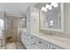 Bathroom showcasing a modern glass shower, double sinks, and classic white cabinetry at 4721 Country Manor Dr, Sarasota, FL 34233