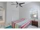 A bright bedroom featuring a ceiling fan and a neutral palette, complemented by tile flooring at 4721 Country Manor Dr, Sarasota, FL 34233