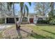 Charming single-story home featuring a well-manicured lawn and a beautiful, mature palm tree in the front yard at 4721 Country Manor Dr, Sarasota, FL 34233