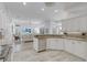 Modern kitchen with granite countertops, stainless steel appliances, and an open layout to the living room at 4721 Country Manor Dr, Sarasota, FL 34233