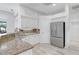 Bright kitchen features granite countertops, stainless steel refrigerator, and ample cabinet space at 4721 Country Manor Dr, Sarasota, FL 34233