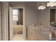 Bathroom featuring marble countertops, double vanity, neutral tones, and a view into bedroom at 8073 Antwerp Cir, Port Charlotte, FL 33981