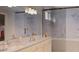 Bright bathroom boasting dual sinks, marble countertops, tiled shower, and a walk-in closet at 8073 Antwerp Cir, Port Charlotte, FL 33981