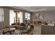 Open-concept living space featuring hardwood floors, neutral tones, natural light, and dining area at 8073 Antwerp Cir, Port Charlotte, FL 33981
