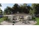 Outdoor patio area with ample seating, umbrellas, and lush landscaping, perfect for entertaining at 8259 Tracy Cir, Port Charlotte, FL 33981