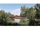Charming one-story home with a three-car garage surrounded by mature trees and lush landscaping at 8259 Tracy Cir, Port Charlotte, FL 33981