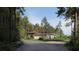 Attractive single-story home nestled among towering trees on a quiet, paved road at 8259 Tracy Cir, Port Charlotte, FL 33981