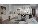 Well-lit kitchen and dining area with white cabinets, stainless steel appliances, and a center island at 8259 Tracy Cir, Port Charlotte, FL 33981