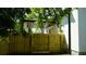 A backyard with a wood fence, trees, and the side of the house at 2604 E 11Th Ave, Tampa, FL 33605