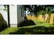 A backyard with a wood fence, trees, and the side of the house at 2604 E 11Th Ave, Tampa, FL 33605
