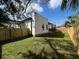 Spacious, grassy backyard, enclosed with a wooden fence for privacy and security at 2604 E 11Th Ave, Tampa, FL 33605