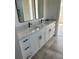 Elegant bathroom featuring dual sinks, granite countertops and modern fixtures at 2604 E 11Th Ave, Tampa, FL 33605