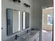 Modern bathroom with double sinks, marble countertop, and dark accents at 2604 E 11Th Ave, Tampa, FL 33605