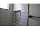 Modern bathroom shower featuring subway tile surround and convenient storage niche at 2604 E 11Th Ave, Tampa, FL 33605