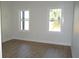 Bright bedroom with hardwood floors and natural light from two windows at 2604 E 11Th Ave, Tampa, FL 33605
