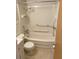 Bathroom features a shower-tub combo with safety rails, toilet, and vanity with a marble countertop at 4143 57Th N St # 502, Kenneth City, FL 33709